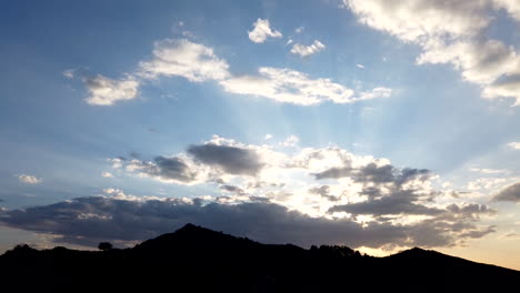 mountain silhouette with clouds and sunlight