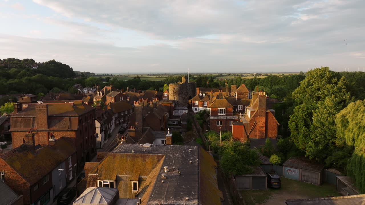 Flying Over The Old Street Towards The Landgate At Sunset In Rye Town, England, UK. - aerial shot