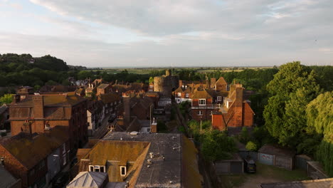 flying over the old street towards the landgate at sunset in rye town, england, uk. - aerial shot