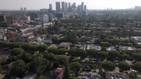 urban beverly hills neighborhood with century city in the background, rising aerial shot.