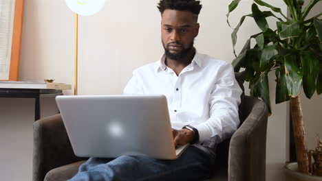 wide of man using a laptop with a serious face