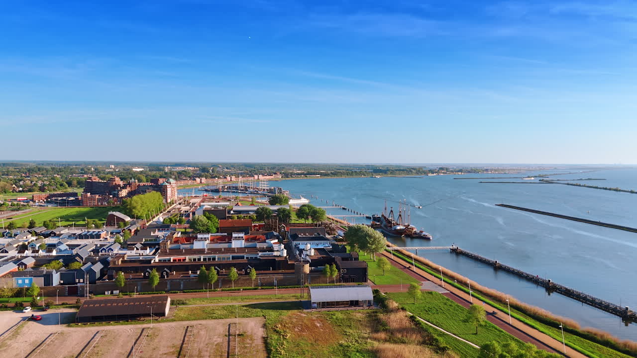 Scenic view of Lelystad, the Netherlands and Lake Markemeer. Approaching the wharf, museum Batavialand and ships at the berth.