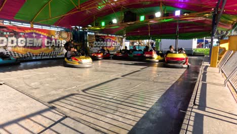 people enjoying bumper cars at a fun fair