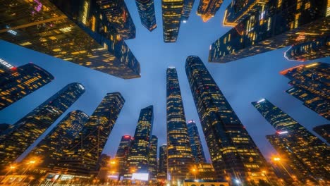 low angle view of illuminated skyscrapers at night