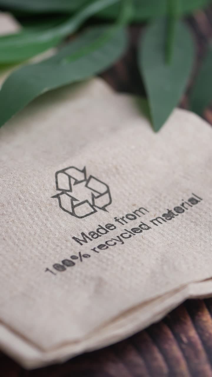 Close-up of a Recycled Napkin with Recycling Symbol and Text