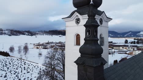 aerial shot of church, during winter, near village