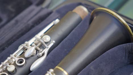 close up panning shot of a clarinet in a purple open case on display