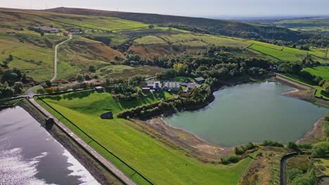 aerial drone video footage taken at ogden near saddleworth moor of a series of lakes, reservoirs, set against a backdrop of moorland and woodlands