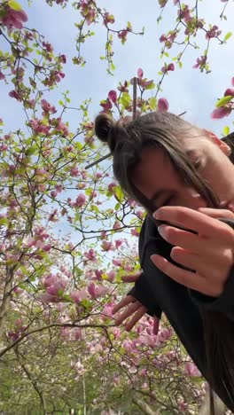 woman under magnolia trees in bloom