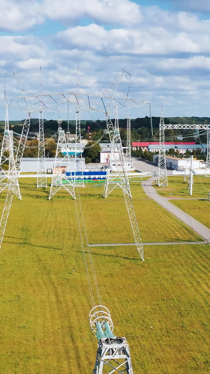 Electrical power distribution system. Aerial view of electric high voltage construction. Vertical video