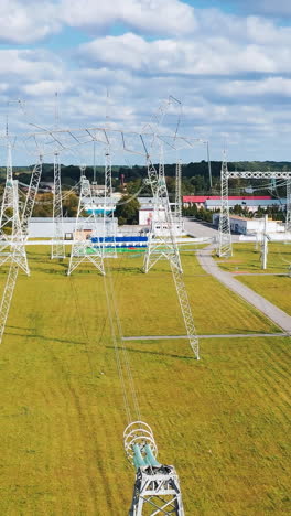 electrical power distribution system. aerial view of electric high voltage construction. vertical video