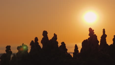 the sun goes over the towers of the sand castle mirage and fluctuation concept 4k video