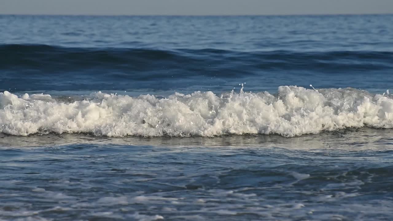 Blue sea waves at sunlight