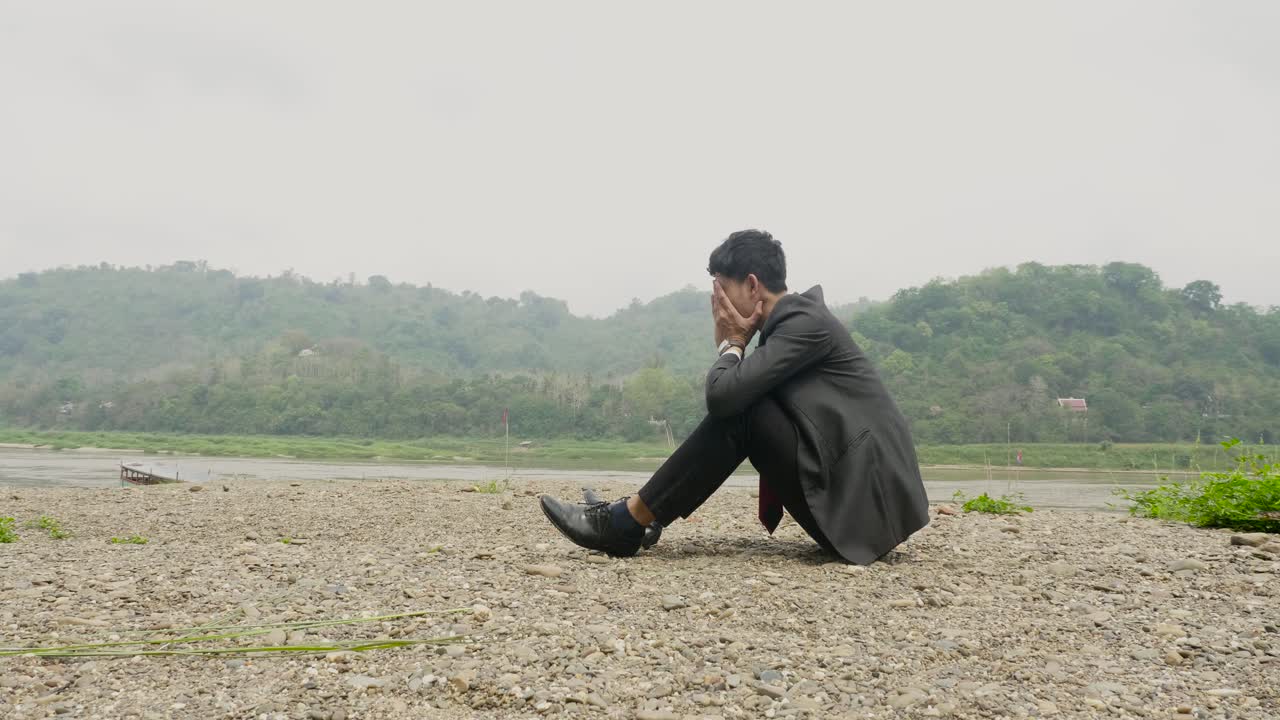 Depressed Businessman by the River