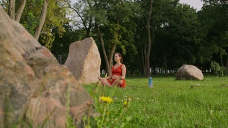 pregnant woman meditating in a park