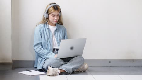 two asian girls student partners are working on a laptop help study together
