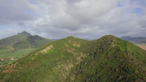 flying over green hill on mauritius island