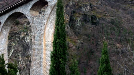 aerial push in shot below the pont séjourné in fontpédrouse, france in the catalan pyrenees