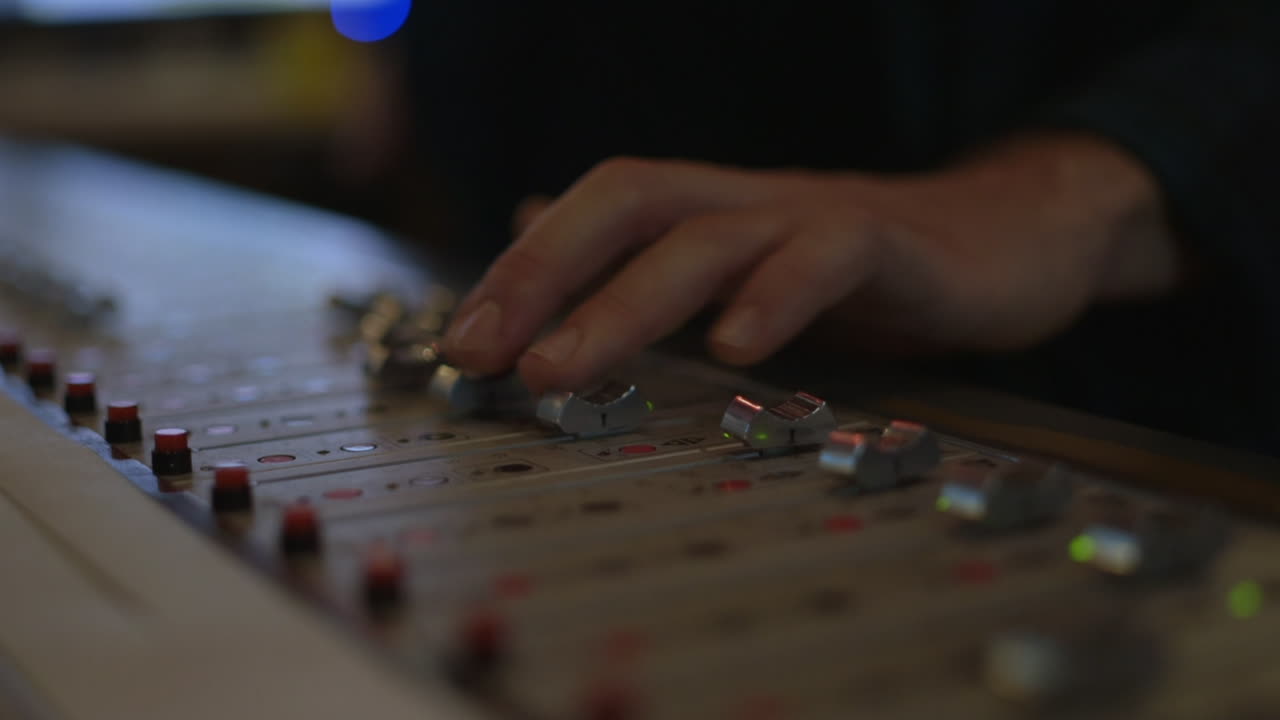 A person adjusting sliders on a control panel