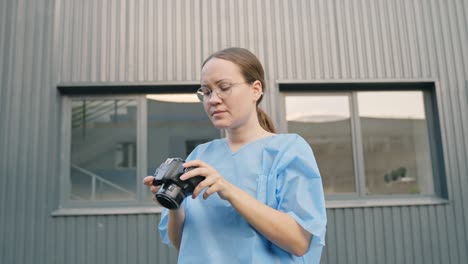 woman photographing a crime scene investigation wearing a blue protective outfit