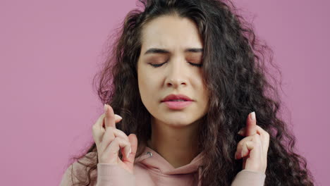 woman hoping, fingers crossed