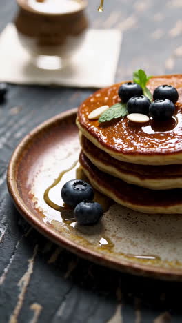 fluffy pancakes with maple syrup and blueberries