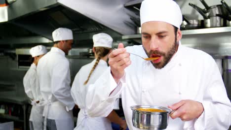 chef tasting food in the kitchen