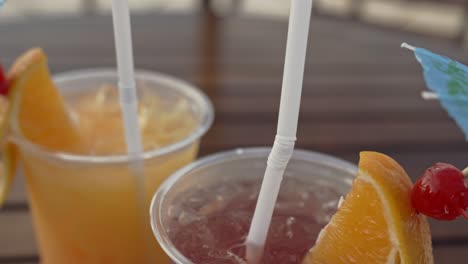 top view of cocktail drinks with orange and cherry on an umbrella stick