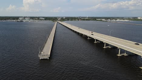 green bridge and fishing pier extending over water, looking toward palmetto, florida. orbit left