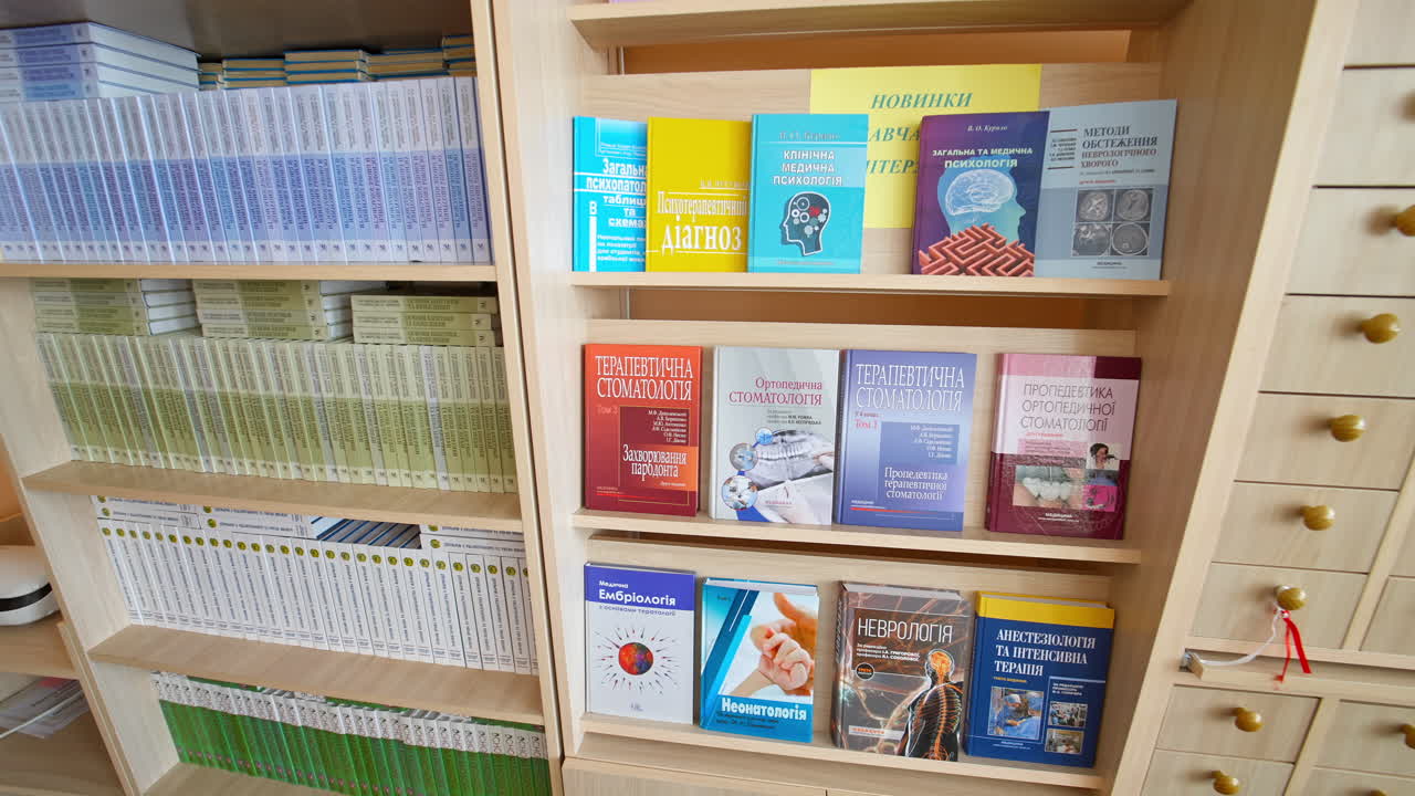 Books on bookshelf in library. Rows of different colorful books lying on the shelves