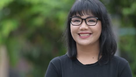 beautiful happy asian businesswoman thinking in the streets outdoors