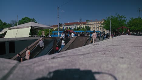 people riding an escalator in a busy city street