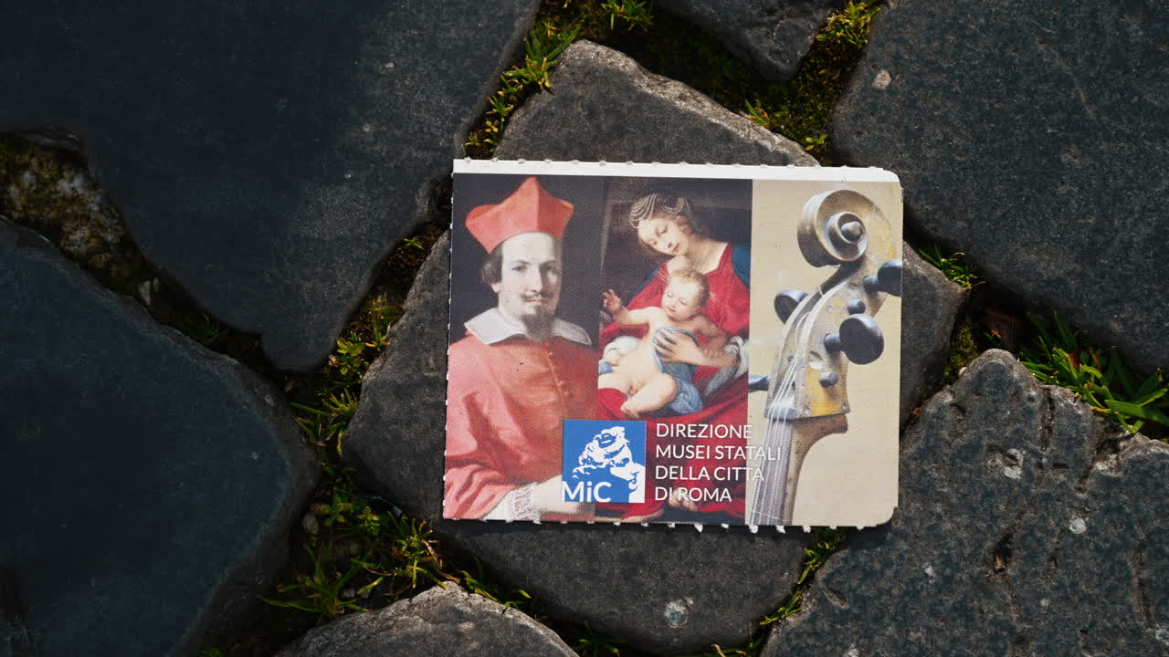 A part of a museum ticket on pavement in Rome, Italy