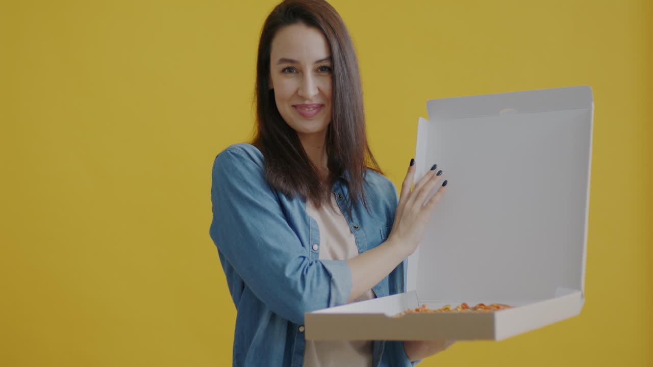 Woman holding a pizza box