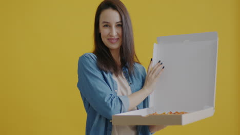 woman holding a pizza box