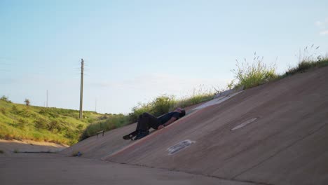 person lays in a ditch the ground from exaustion