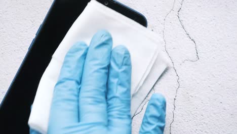 cleaning a smartphone with gloves