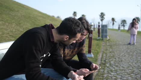 two men spend time with phone