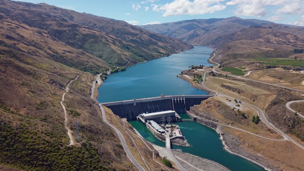 Aerial view of Clyde Dam, New Zealand, with Lake Dunstan and mountains