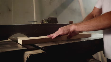 carpenter using a planer on a wooden plank