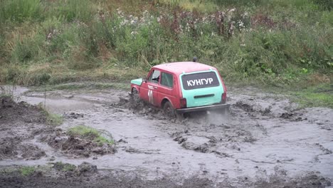 off-road vehicle driving through muddy terrain