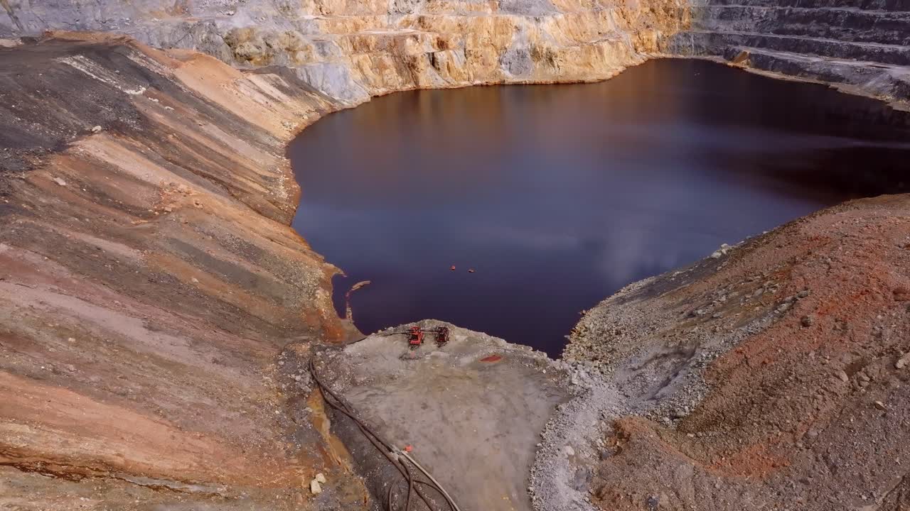 Drone view of large tailings pond with discolored water at Barrick Gold Pueblo Viejo mine. Highlights industrial impact and water management. Dominican Republic