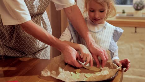 mother and daughter baking cookies together