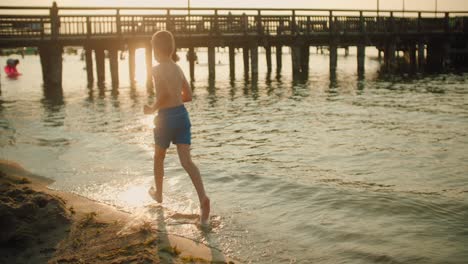 kid running on the beach slow motion