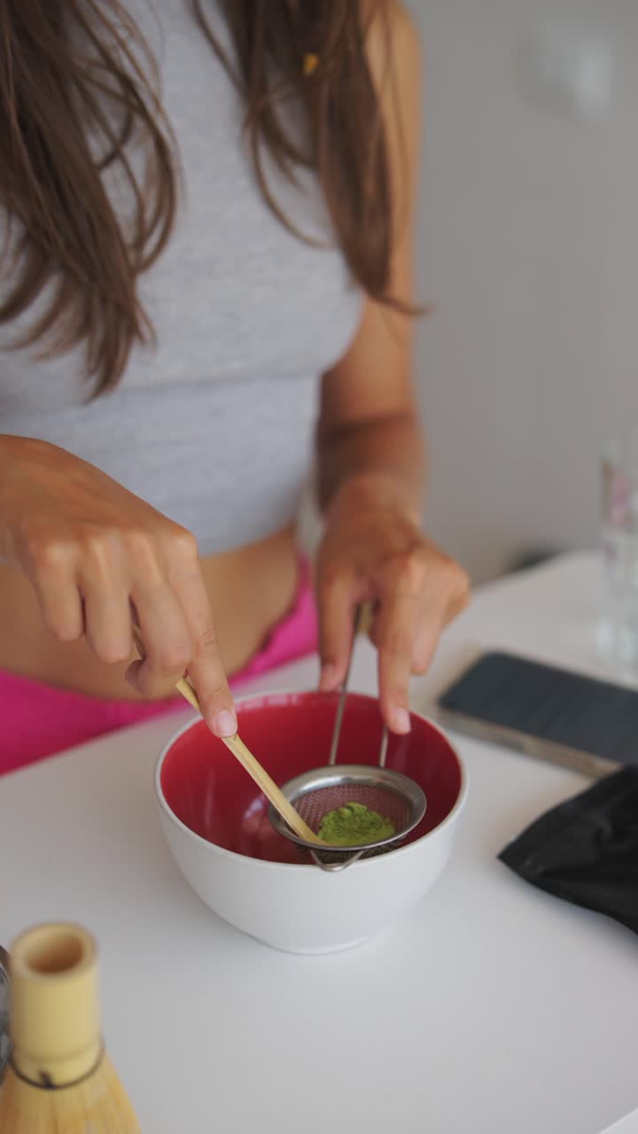 Hands Sifting Matcha Powder into a Bowl