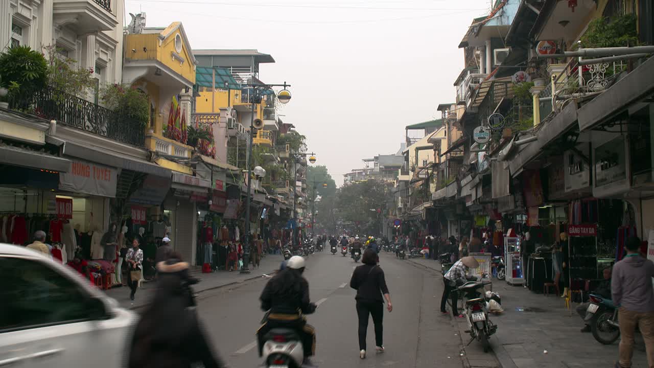The busy street of a business district in Hanoi, Vietnam - wide shot