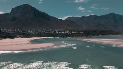 Lagoon-mouth-open-to-the-ocean-with-mountains-in-the-distance