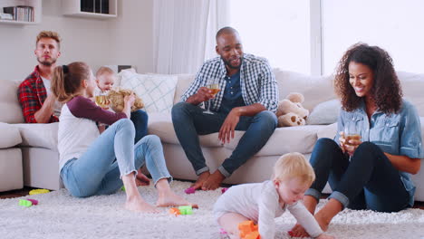 friends with toddlers playing and socialising at home