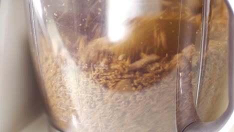 close-up of cookies - biscuits being crushed in a blender