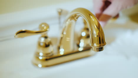 open a tap with water in a luxurious bathtub